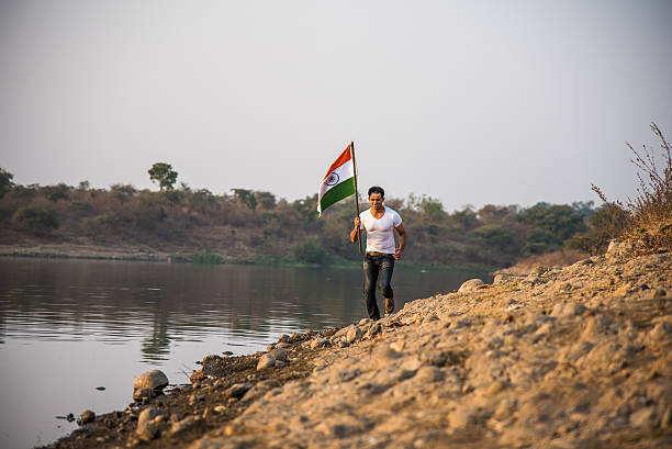 istock indian young man waving indian flag 564562610