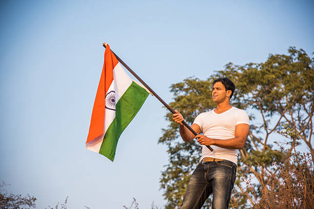 istock indian young man waving indian flag 564562724