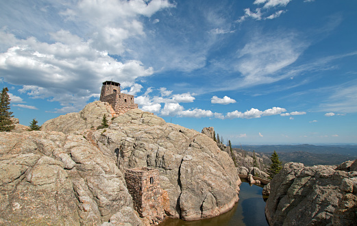 Harney Peak Fire Lookout Tower with pumphouse and small dam in part of the Black Elk Wilderness in Custer State Park in the Black Hills of South Dakota USA. The Harney Peak Fire Lookout Tower was built by the Civilian Conservation Core in 1938.