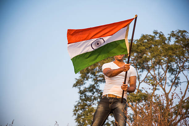istock indian young man waving indian flag 564562906