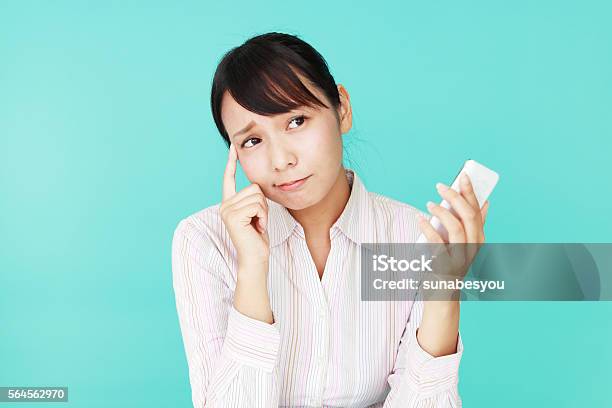 Woman With A Smart Phone Stock Photo - Download Image Now - Colored Background, Failure, Worried