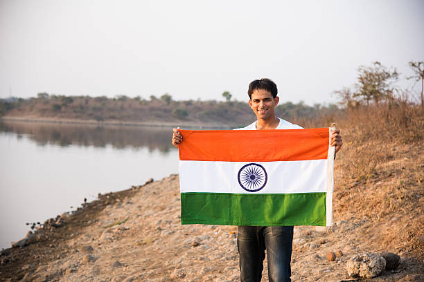 istock indian young man waving indian flag 564563180