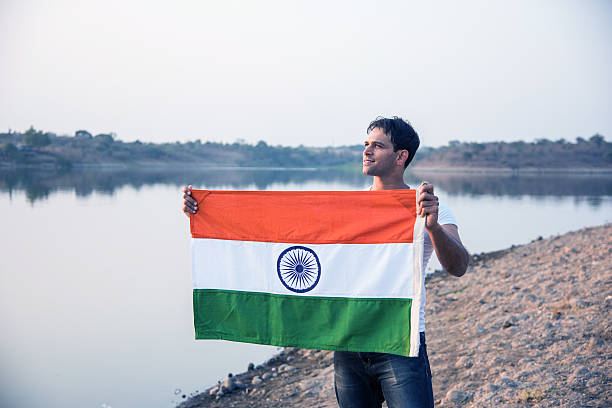 istock indian young man waving indian flag 564563378