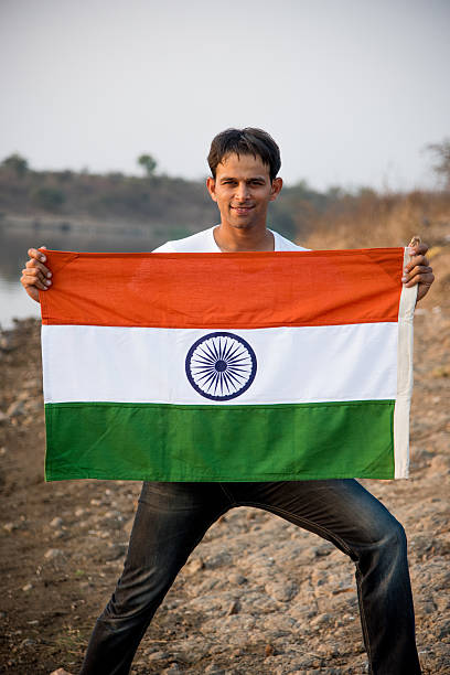 istock indian young man waving indian flag 564563566