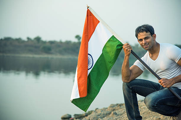 istock indian young man waving indian flag 564563638