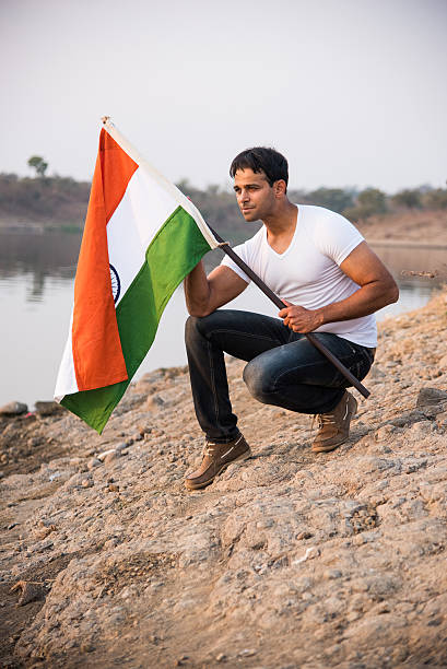 istock indian young man waving indian flag 564563658