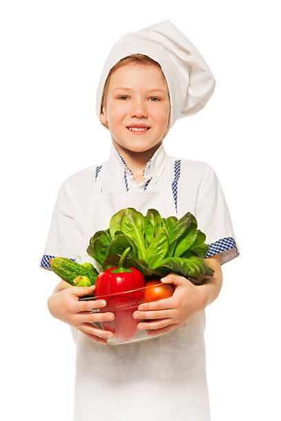 istock Young smiling cook with bowl of fresh vegetables 564566984