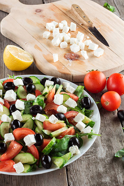 istock Greek salad closeup. Ingredients in background 564567074