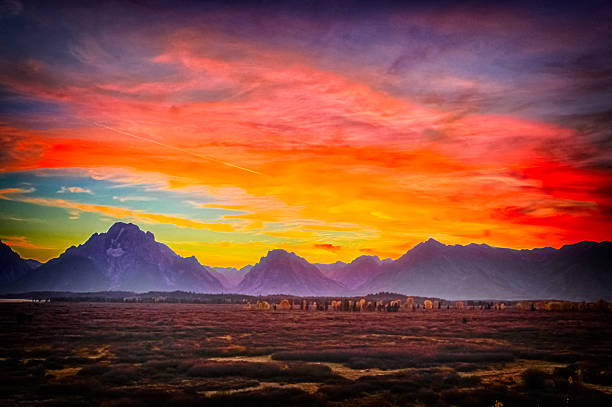istock burning sky and Grand Teton mountains at sunset. 564567650