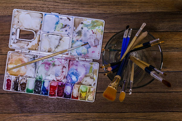 istock Artistic equipment: paint, brushes and art palette 564567762