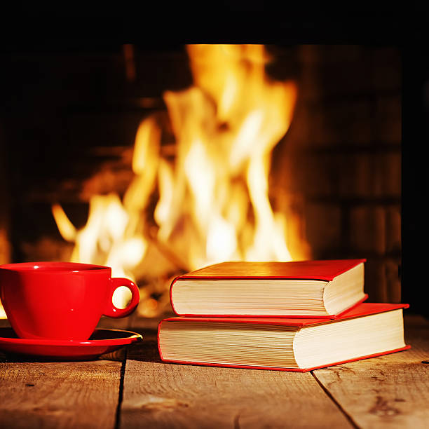 istock Red cup of tea or coffee and old books 564567768