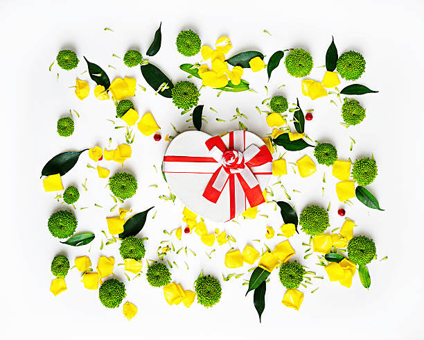 istock Gift in shape of heart with pattern from petals. 564567872