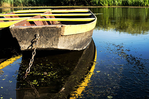 istock Row boat floating on the lake and reflects in it 564567890