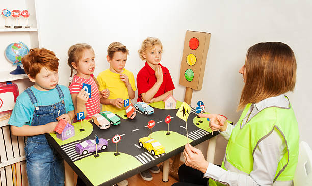 istock Happy kids teaching traffic signs in kindergarten 564569608