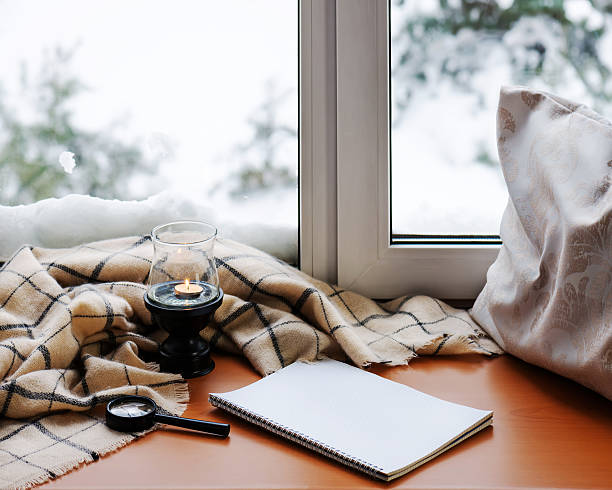 istock Open notepad, magnifier glass, pillow, candle and beige warm pla 564569620