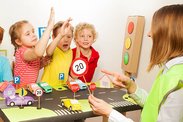 istock Smart happy kids studying traffic regulation rules 564569646