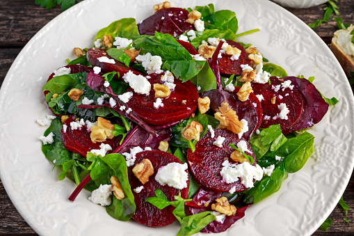 Healthy Beet Salad with fresh sweet baby spinach, kale lettuce, nuts, feta cheese and toast with melted cheese.