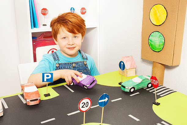 istock Cute redheaded boy playing driver in kindergarten 564571152