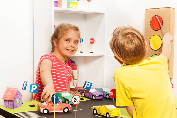 istock Kids having fun playing with cars and signs models 564571402