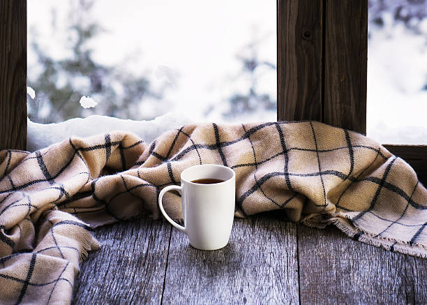 istock White cup of coffee or tea on stylized window sill. 564573778