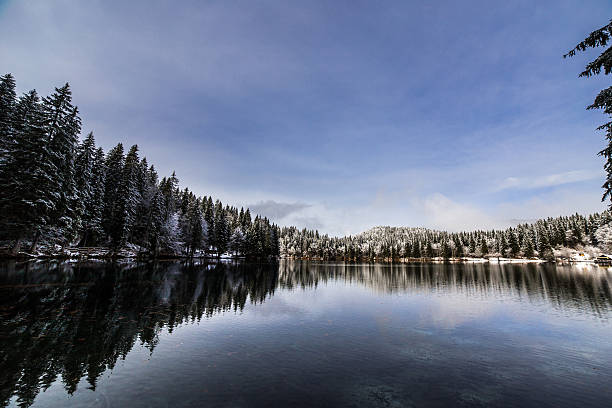 istock first snow at the mountain lake 564573780
