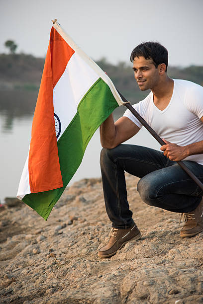 istock indian young man waving indian flag 564574336