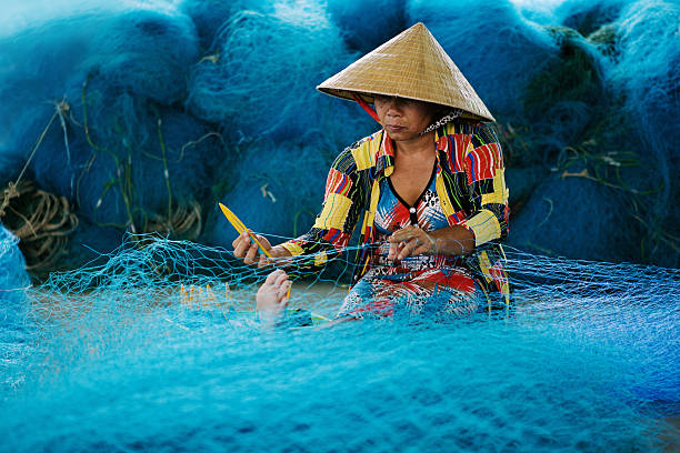 istock Fishing net mending in Bac Lieu, Mekong Delta, Vietnam 564575218