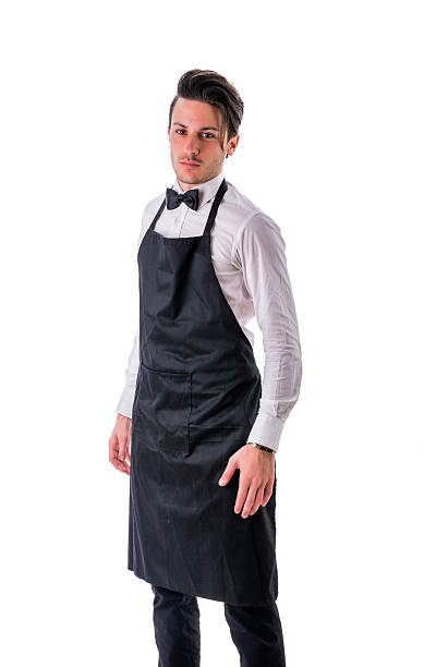 istock Young chef or waiter wearing black apron isolated 564577212