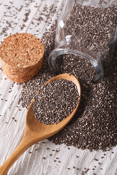 istock Chia seeds are poured out from a jar closeup 564577910