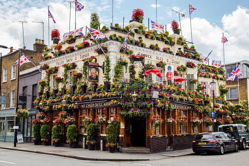 London, UK - June 28, 2016: A view of the outside of the Churchill Arms in London. Large amounts of flowers and UK decorations can be seen on the exterior.