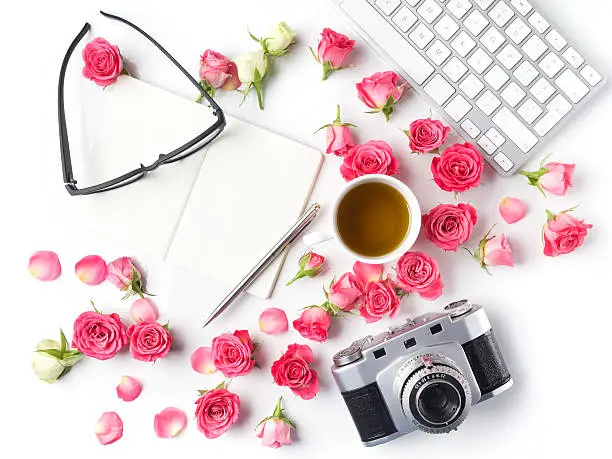 Photo of Vintage camera pink roses and note on white background. Flat