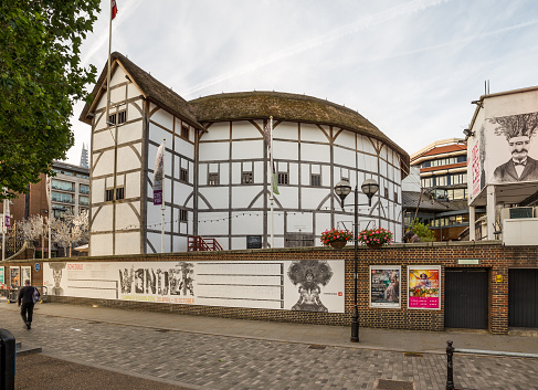 London, UK - July 6, 2016: A view of the outside of Shakespeares Globe Theatre in the morning. A person can be seen.