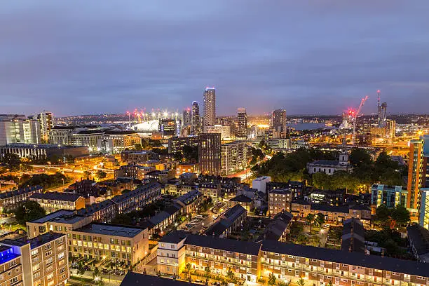 A view of apartment buildings towards the 02 Arena in East London at night