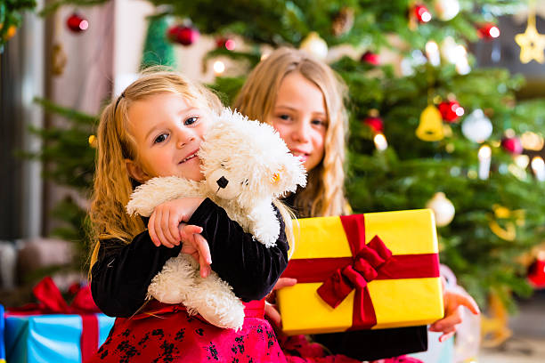 istock Children receiving presents on Christmas day 564579896