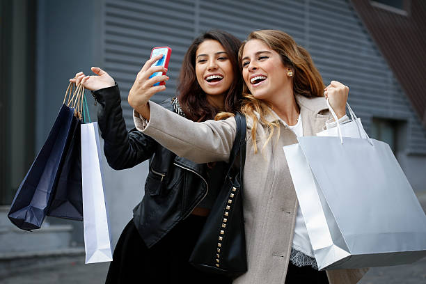 istock Young women with shopping bags 564581434