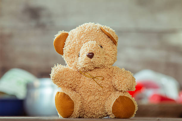 Cute teddy bears sitting on old wood background