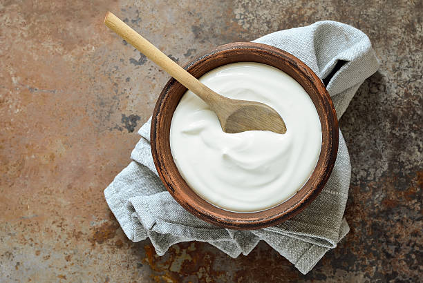 Homemade yogurt Homemade yogurt or sour cream on a rustic background, view from above yogurt stock pictures, royalty-free photos & images