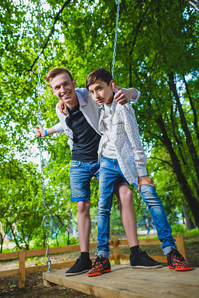 istock Smiling boys having fun at playground. Children playing outdoors in 564584036