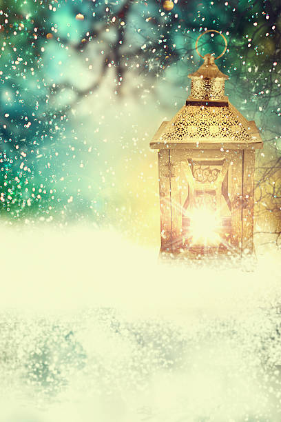 istock Christmas lantern in the snow at nigh 564585512