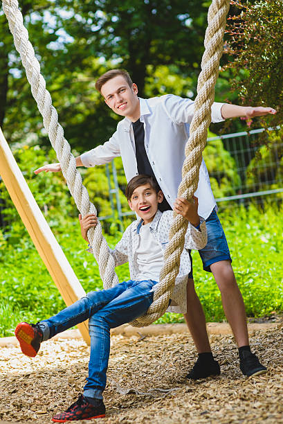 istock Smiling boys having fun at playground. Children playing outdoors in 564585676