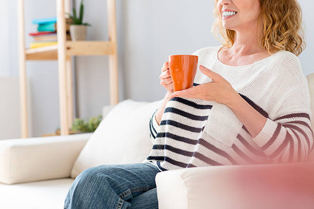 istock Senior lady relaxing with hot drink 564587528