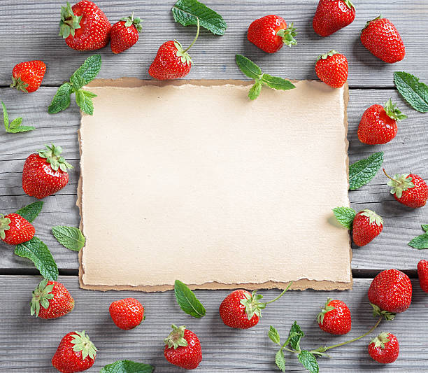 istock Old paper with Big strawberry and mint leaf 564587716