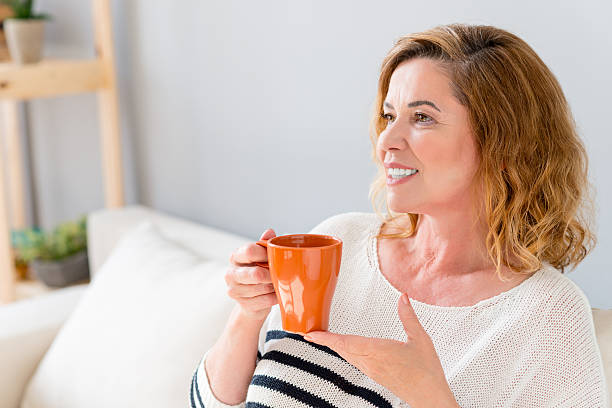 istock Joyful mature lady relaxing at home 564587794