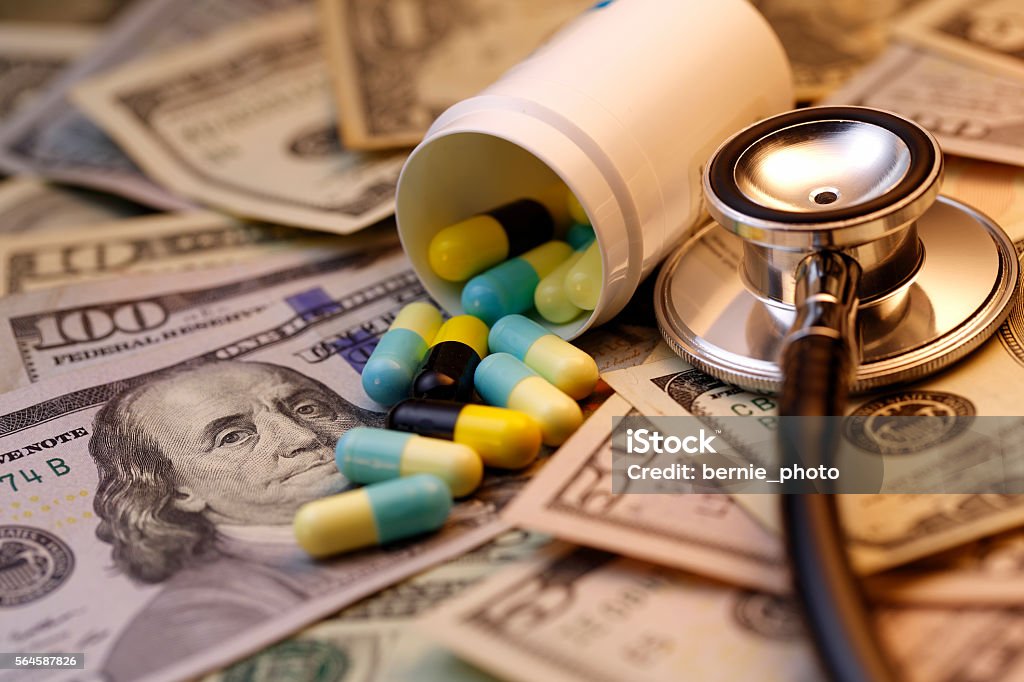 High Cost of Healthcare Cost of health care, High medical costs in dollar bills background Pill Stock Photo