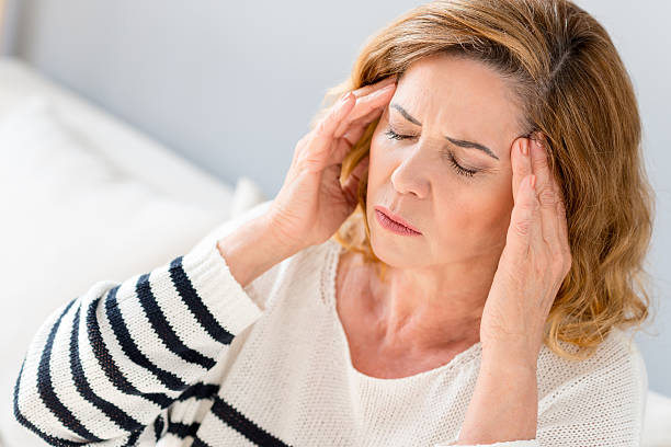 istock Mature lady suffers from headache 564588220