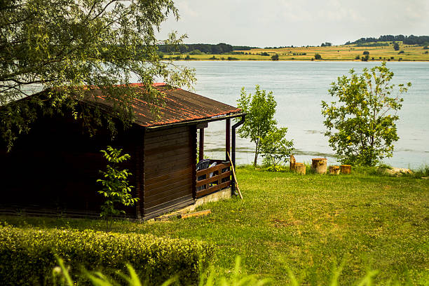 istock Wooden house on lake. 564588380