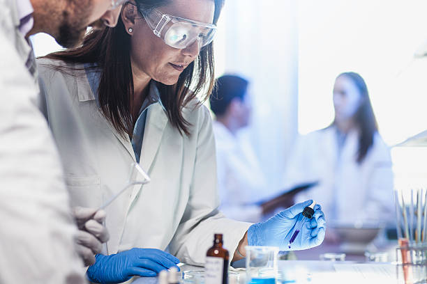 istock Scientists Placing Reagents into a Petri Dish 564588814