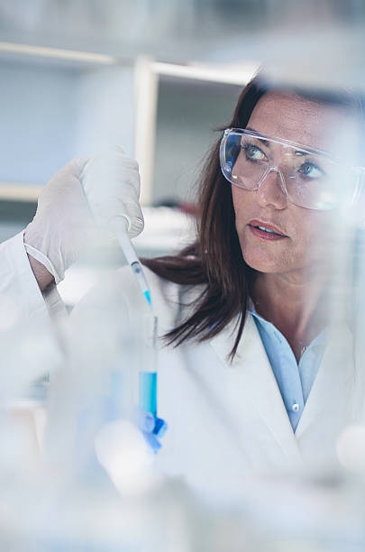 istock Scientists Pipetting Into a Test Tube 564588952