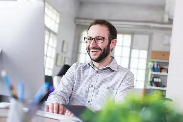 Photo of Cheerful young man at the work