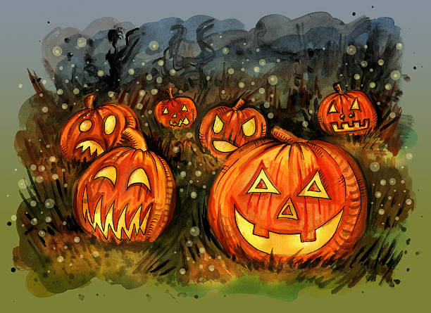istock Group of candle lit carved Halloween pumpkins on the field 564590092